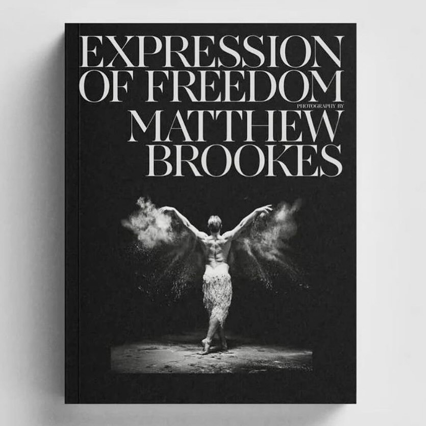 Book cover featuring a black and white image of a dancer surrounded by powder, with white serif typography reading Expression of Freedom by Matthew Brookes