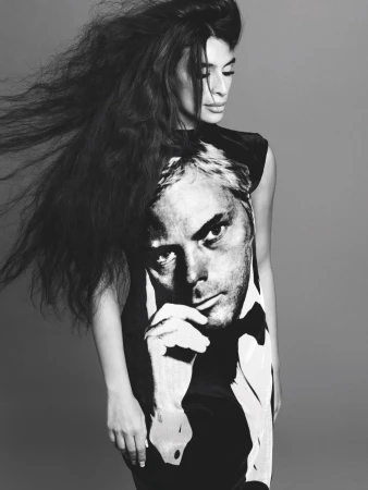 Black and white portrait of a woman with long voluminous hair wearing a graphic print dress by casting director Maxime Valentini