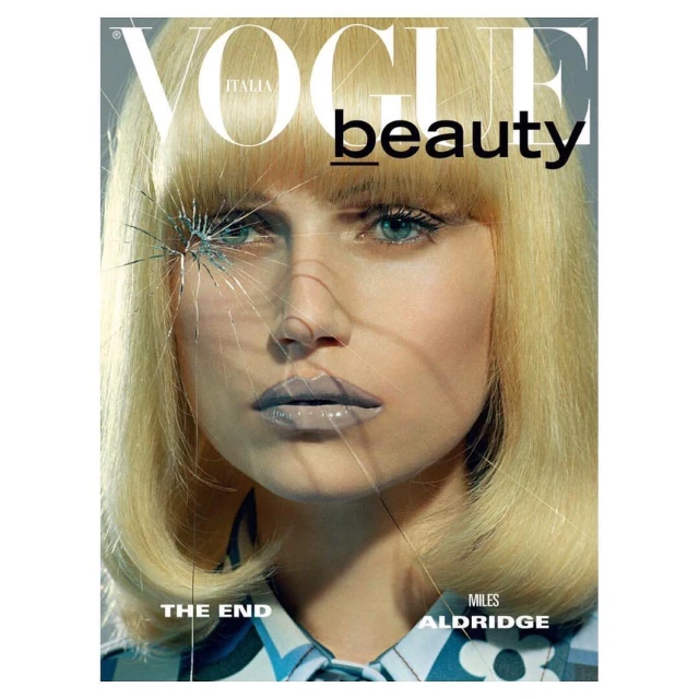 Vogue Italia beauty magazine cover featuring a blonde woman with silver lipstick and stylized blonde hair, with a shattered glass effect.