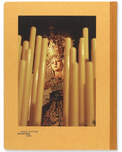 Photograph of a religious icon figure framed by lit candles, featured on the cover of a Louis Vuitton Fashion Eye book with a tan cover.
