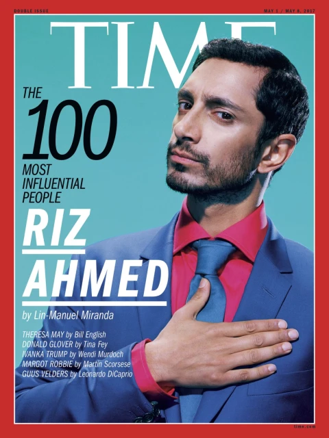 Time Magazine cover featuring Riz Ahmed in a blue suit and pink shirt against a light blue backdrop with red border.