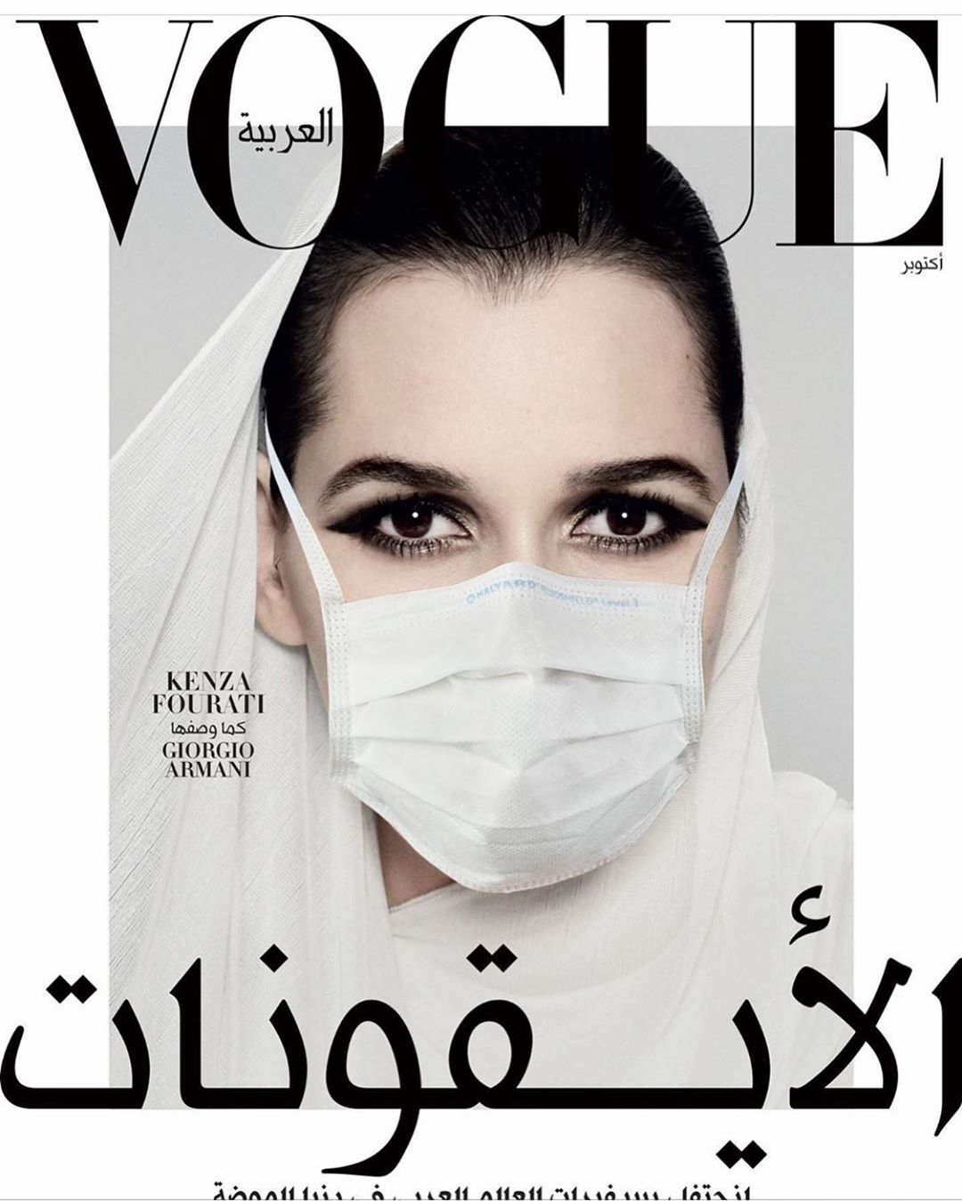 Vogue Arabia magazine cover featuring a woman wearing a hijab and a surgical mask, shot in a photo studio with dramatic lighting.