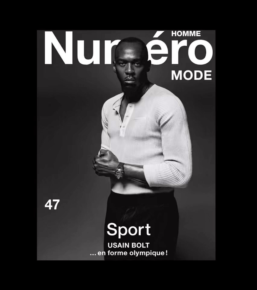 Magazine cover featuring a black and white portrait of Usain Bolt in a light coloured shirt and dark pants on a grey background.