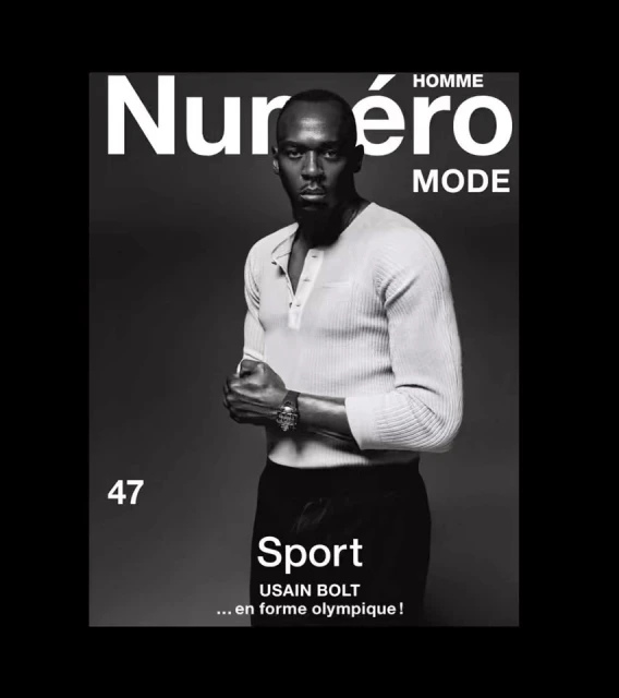 Magazine cover featuring a black and white portrait of Usain Bolt in a light coloured shirt and dark pants on a grey background.