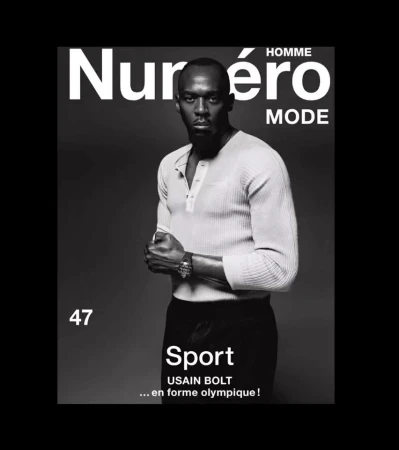 Magazine cover featuring a black and white portrait of Usain Bolt in a light coloured shirt and dark pants on a grey background.