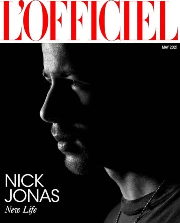 L'Officiel magazine cover featuring a silhouetted profile of Nick Jonas against a dark background, with the magazine's title in red text.