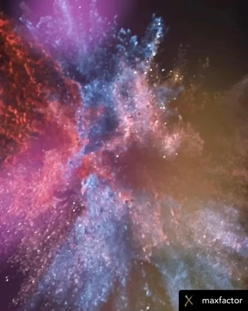 Abstract splash of blue, purple, orange, and pink dust powder against a dark background with the logo 'maxfactor' at the bottom.