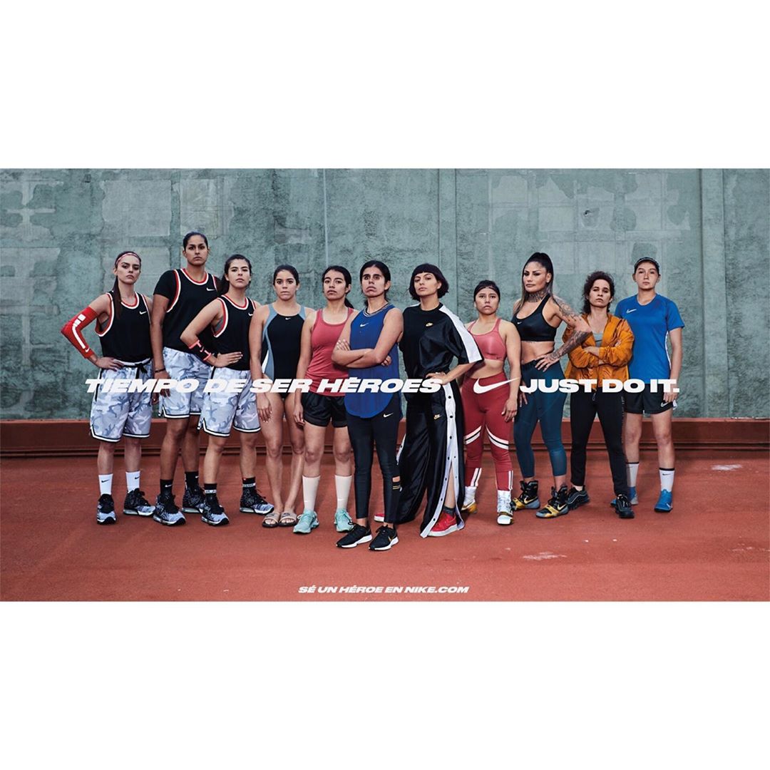 Group of women athletes in Nike apparel standing together for a promotional image, emphasizing sportswear and athletic community.