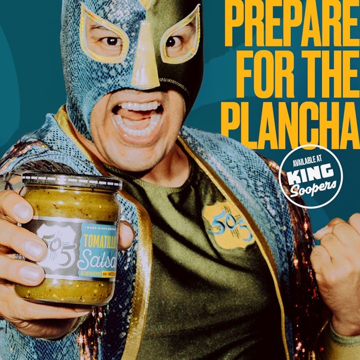 Man in lucha libre mask holds tomatillo salsa jar in close-up, with 'Prepare for the Plancha' text. King Soopers logo in corner.
