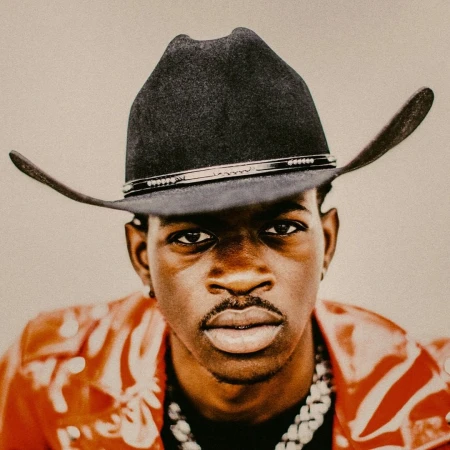 Portrait of a Black man wearing a black cowboy hat and a red patterned jacket by Christaan Felber