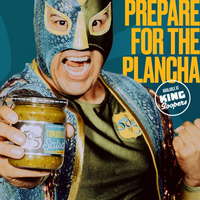 Luchador wrestler in mask holds 505 Southwestern Tomatillo Salsa jar, promoting 'Prepare for the Plancha' at King Soopers.