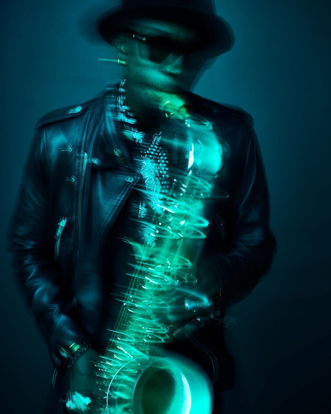 Jazz musician in a black leather jacket plays a glowing cyan saxophone under blue lighting, motion blur, creating a vibrant musical image.