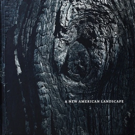 Monochromatic close-up shows a tree trunk's charred, textured bark with a knot, and the title 'A New American Landscape' at the bottom.