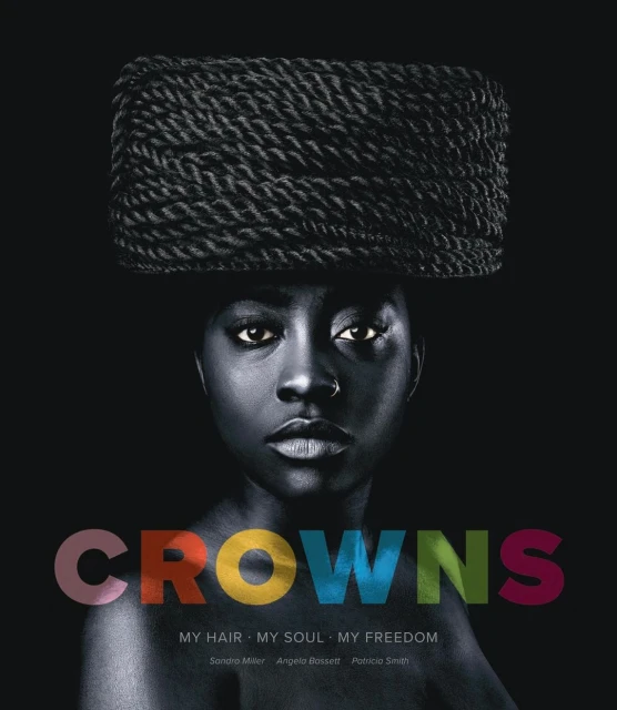 Portrait of an African American woman with braided hair, wearing a nose ring, and colorful text overlayed on a dark background.