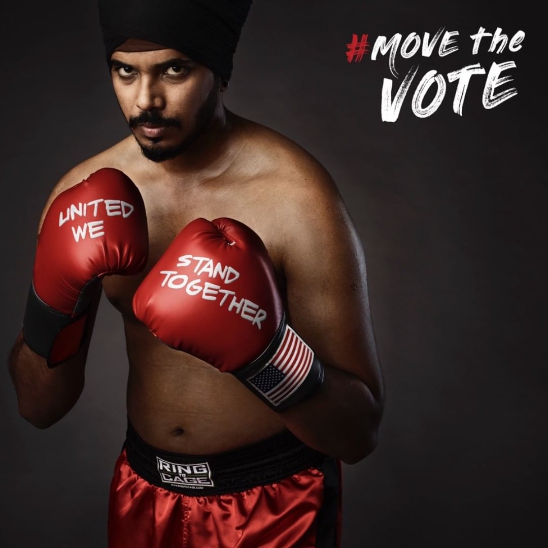 A man wearing a turban and boxing gloves with political slogan, standing in front of gray background with tagline 'Move the Vote'.
