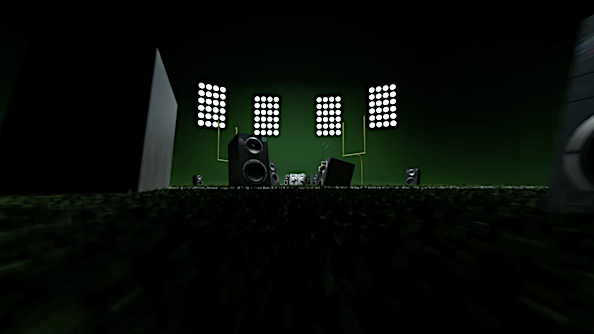 Speaker system featuring various sized speakers arranged in an indoor setting with stage lighting on a dark green background.