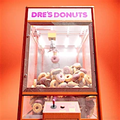 A vintage claw machine filled with donuts, illuminated against a vibrant orange background, featuring the text 'DRE'S DONUTS' on top.
