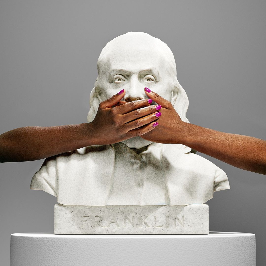 Bust of Benjamin Franklin with hands covering the mouth, studio shot with gray background, hands with vibrant pink nail polish.