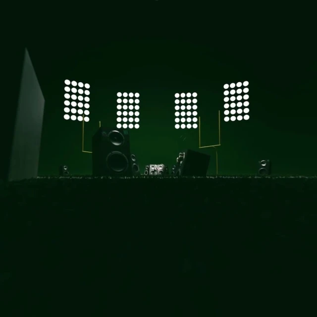 Stage setup with speakers and lighting arrays. The scene is dark, set in a minimalist style with a green color cast.