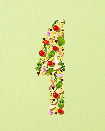 Number one made of salad ingredients on a green background. Food art with tomatoes, onion, cheese, lettuce, pasta and corn.