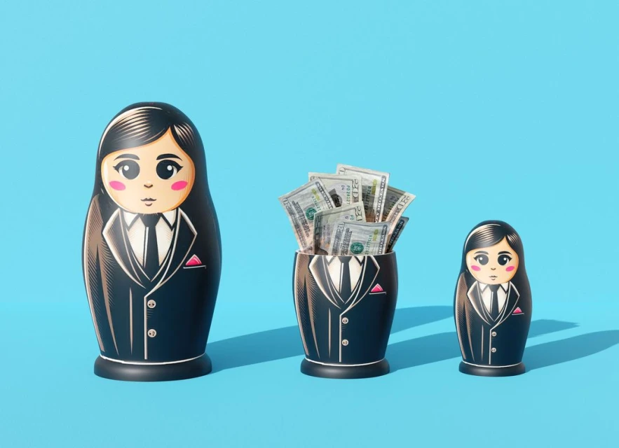Three matryoshka dolls in business suits, one filled with cash, arranged against a bright blue background in a studio setting.