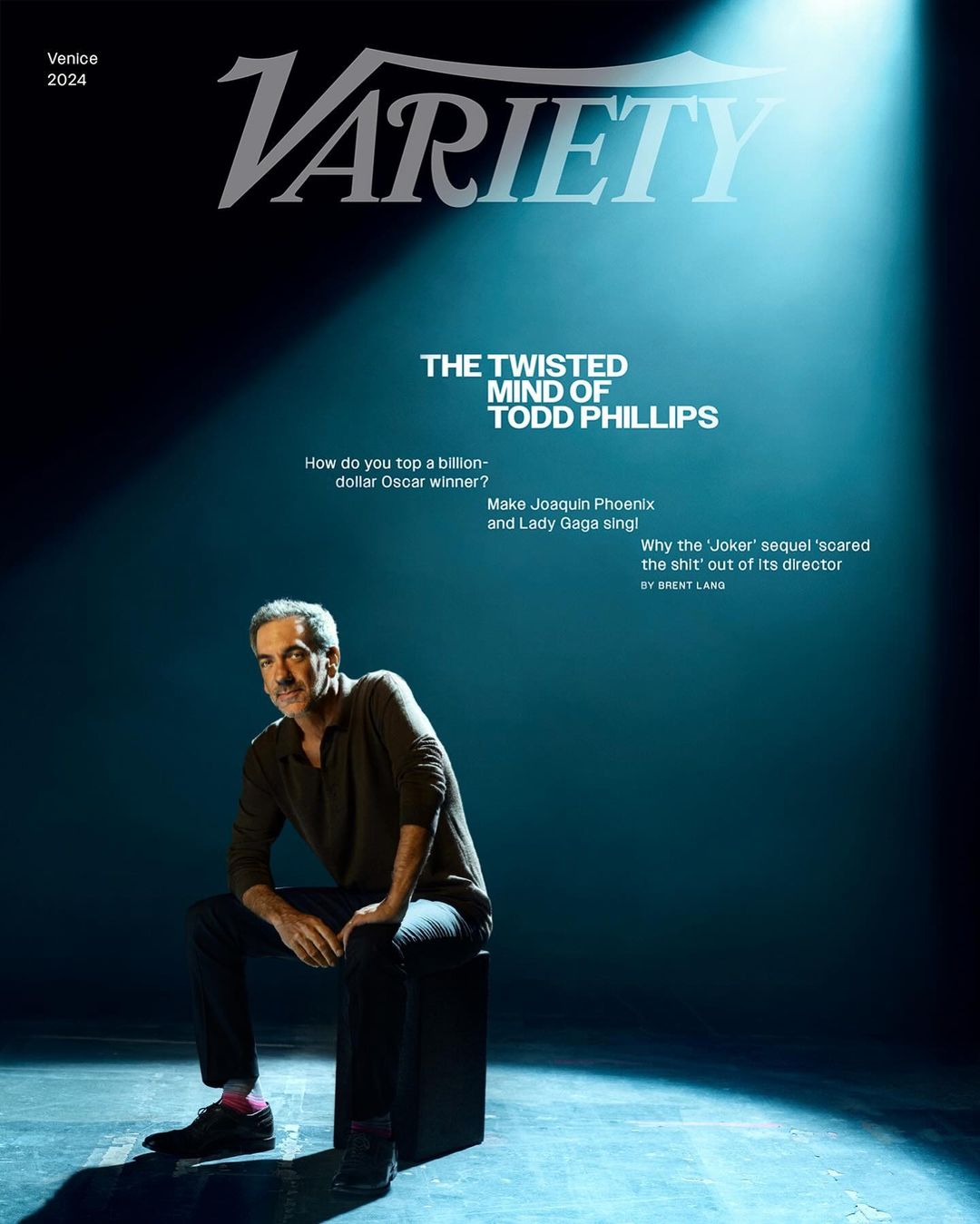 Variety magazine cover featuring Todd Phillips, seated and smiling, in a spotlight against a dark teal background, with the magazine's title.