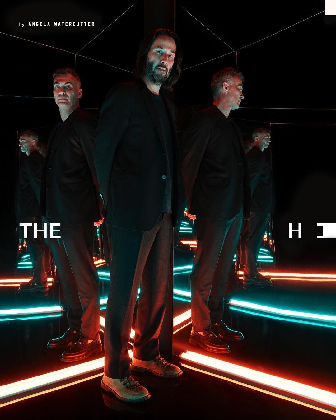 Three adult men are standing in a photo studio with neon lights and reflective walls. One man is centered with the others in mirrors.