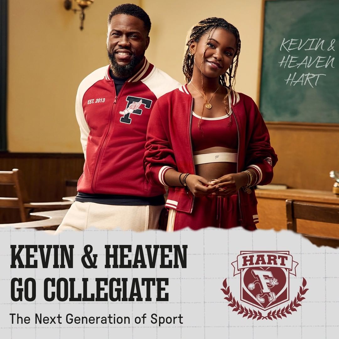 Kevin Hart and Heaven Hart are posing indoors wearing matching sporty red and white varsity jackets and athletic apparel against a classroom background.