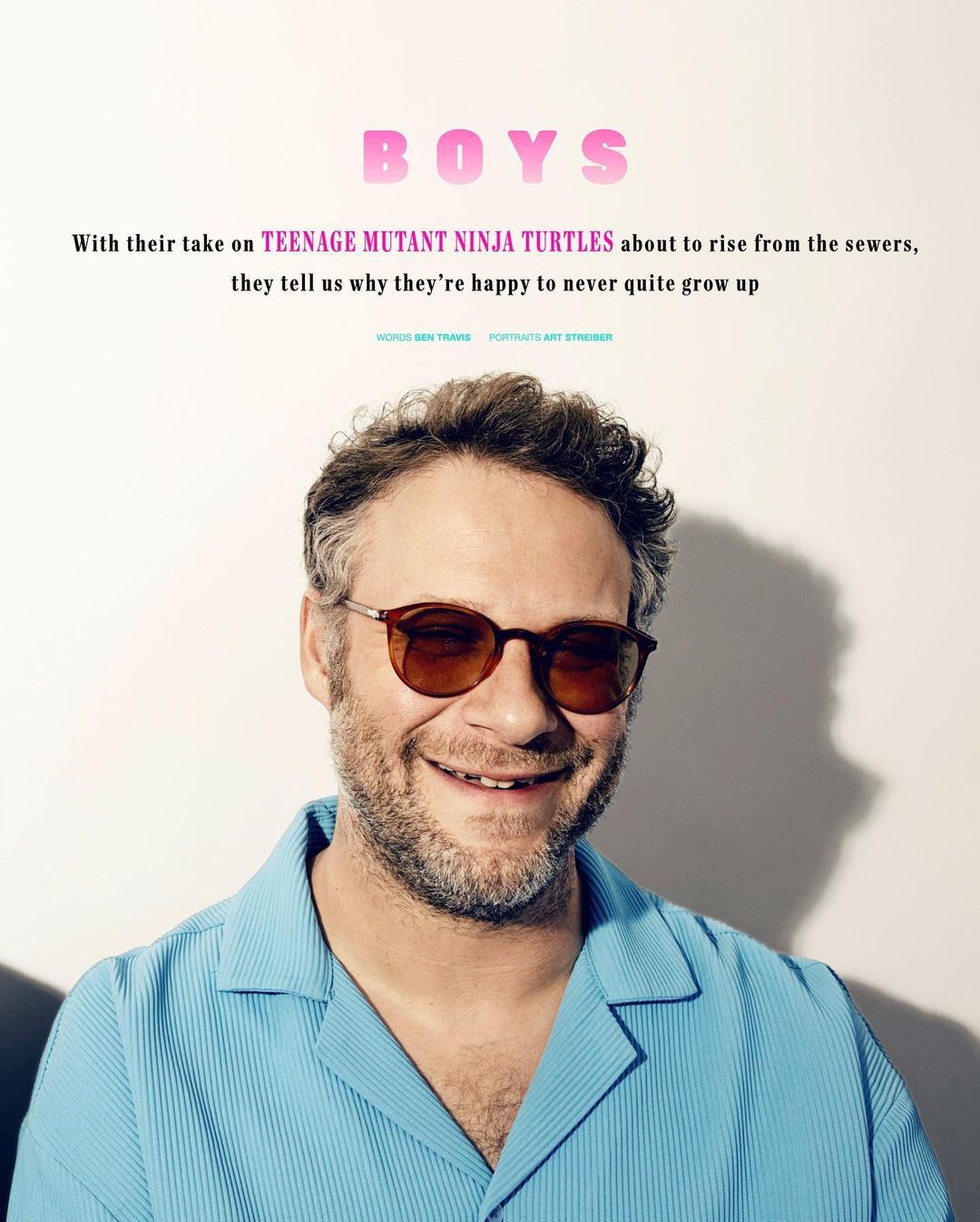 Close-up portrait of a smiling man with glasses wearing a collared blue shirt, against a plain background with magazine text overlay.