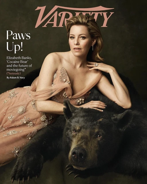Elizabeth Banks on the cover of Variety magazine wearing a peach dress and leaning on a black bear with the magazine's logo visible.