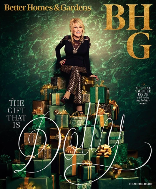 Magazine cover featuring Dolly Parton sitting on a pyramid of wrapped gifts, with a green and gold color scheme for a festive holiday theme.