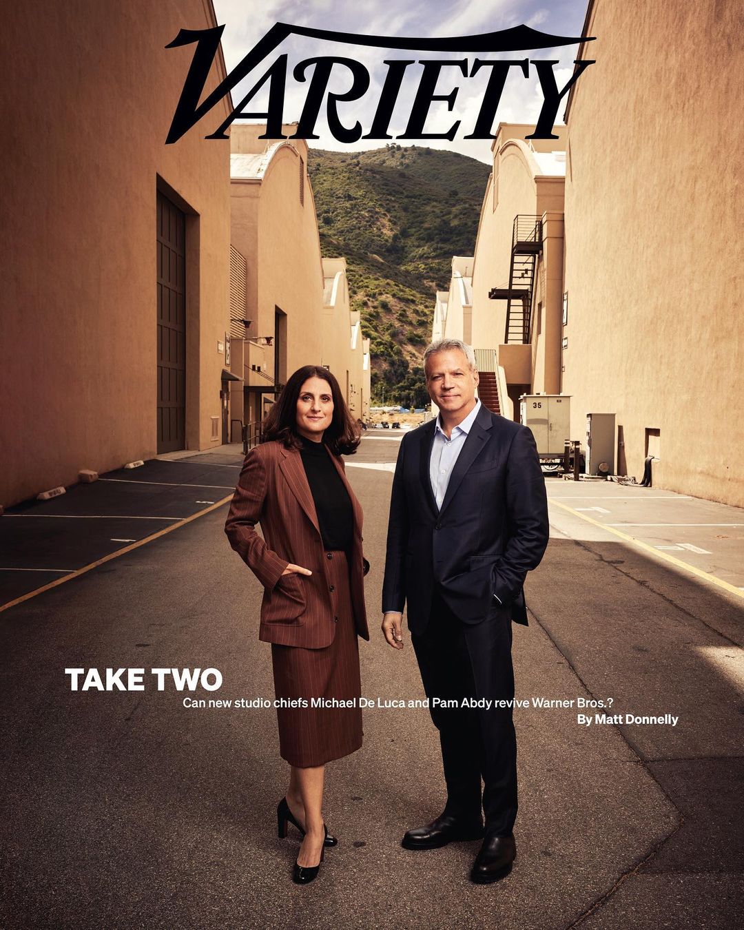 Variety magazine cover featuring a woman in a blazer and skirt standing with a man in a suit on an outdoor studio backlot.