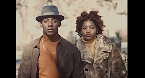 Portrait of a black man wearing a fedora and turtleneck alongside a black woman in a fur-trimmed coat by photographer Braylen Dion.