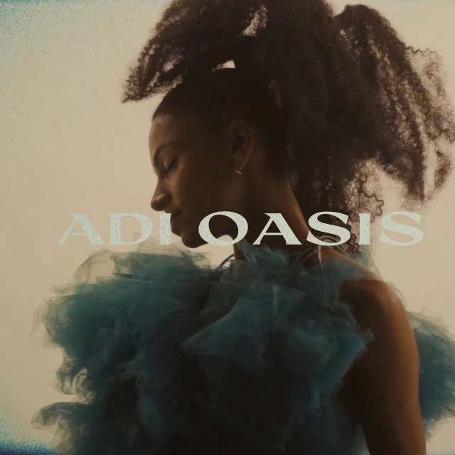 Profile of woman with curly updo wearing a ruffled teal dress against a cream background. The text "ADI OASIS" is overlayed.