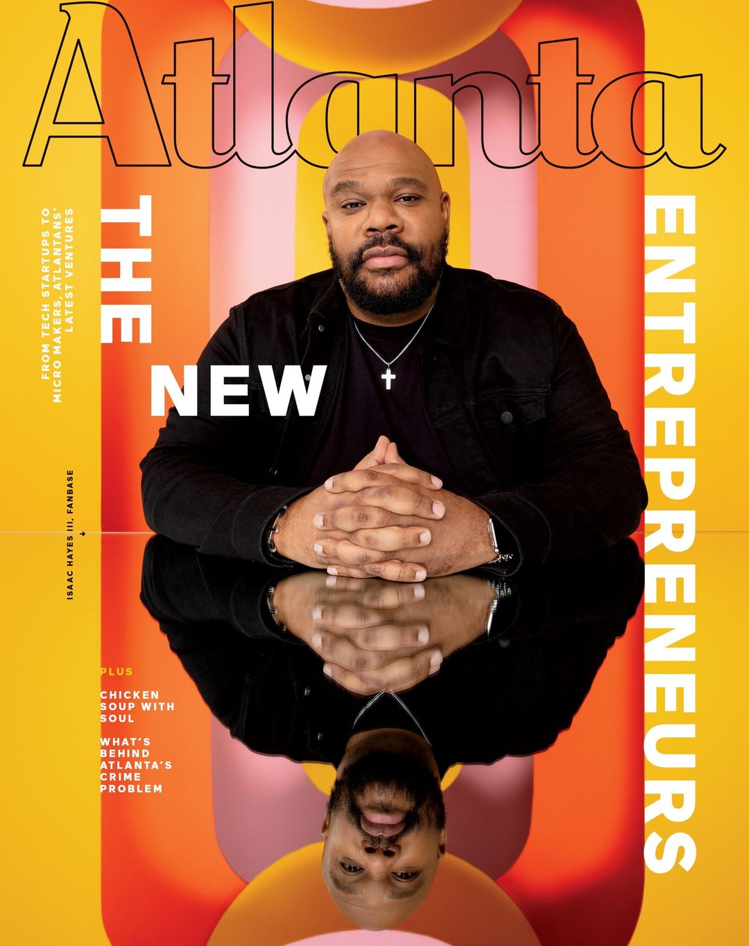 Magazine cover featuring an African-American man in a dark jacket, mirrored reflection, and 'Atlanta' title against a yellow and pink backdrop.