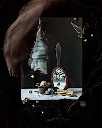 Still life with a mirror reflecting a group of people, a hat, pearls, a brush, and an egg, on a black velvet background.