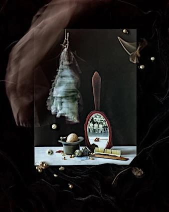 Still life with a mirror reflecting a group of people, a hat, pearls, a brush, and an egg, on a black velvet background.