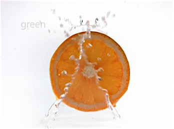 Close-up of an orange slice in mid-splash against a bright white background, with water droplets frozen in air.