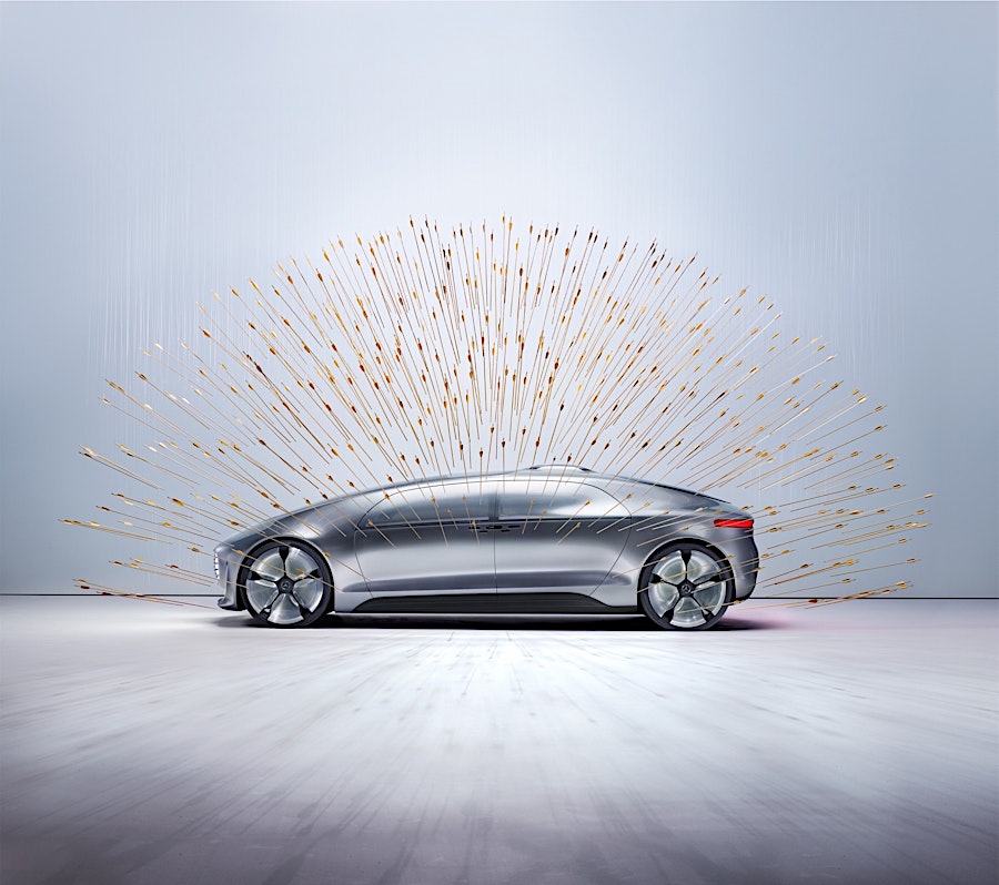 Sleek silver car showcased with a burst of golden light streaks emanating from behind, creating a futuristic, artistic automotive display.