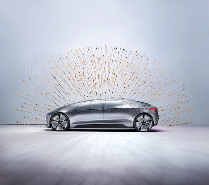 Sleek silver car showcased with a burst of golden light streaks emanating from behind, creating a futuristic, artistic automotive display.