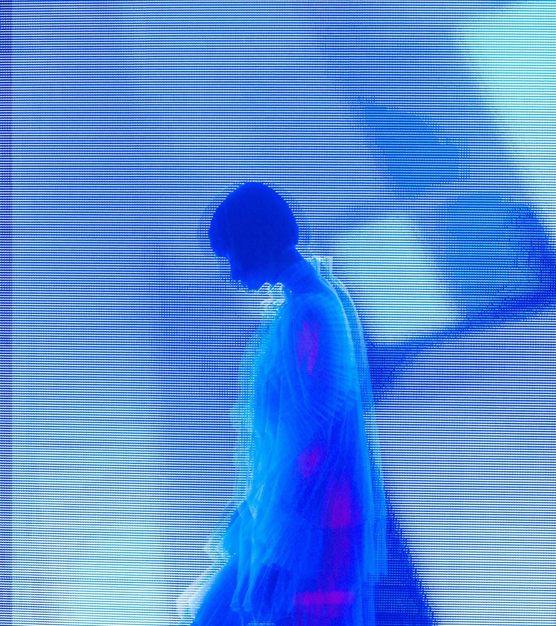 Silhouette of a person in profile against a vibrant blue digital screen backdrop with scan lines.
