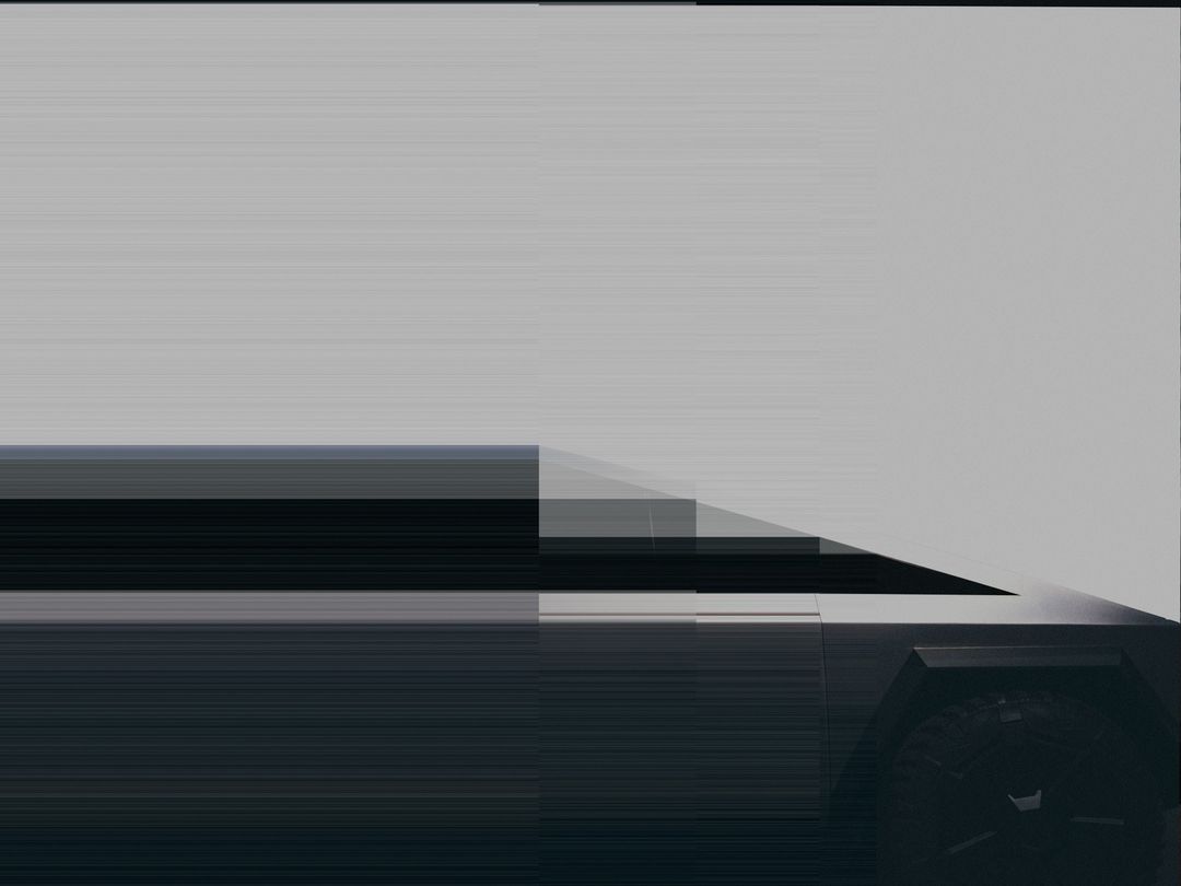 A low-angle shot showcases a sleek, partially visible, futuristic vehicle against a neutral background, emphasizing its modern design elements.