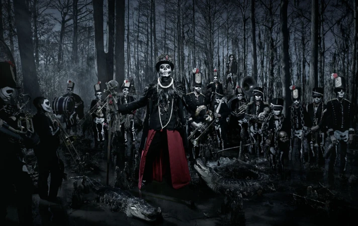 Spooky skeleton brass band with skeleton face paint performs in swampy forest among alligators in a dark, moody photograph.
