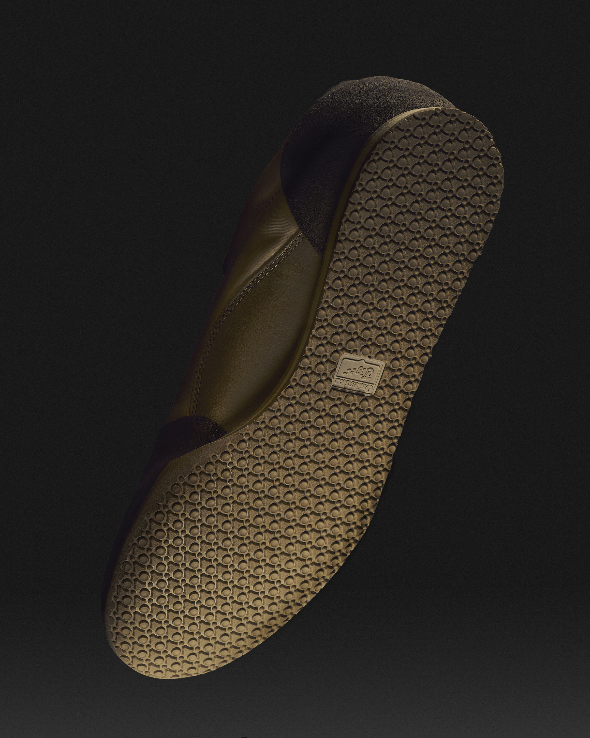 Elevated product shot showcases a brown leather sneaker with a patterned sole against a dark backdrop, highlighting its design.