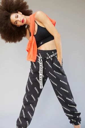 Woman with large afro wearing a black sports bra and branded sweatpants, photographed by Ben Riggot.