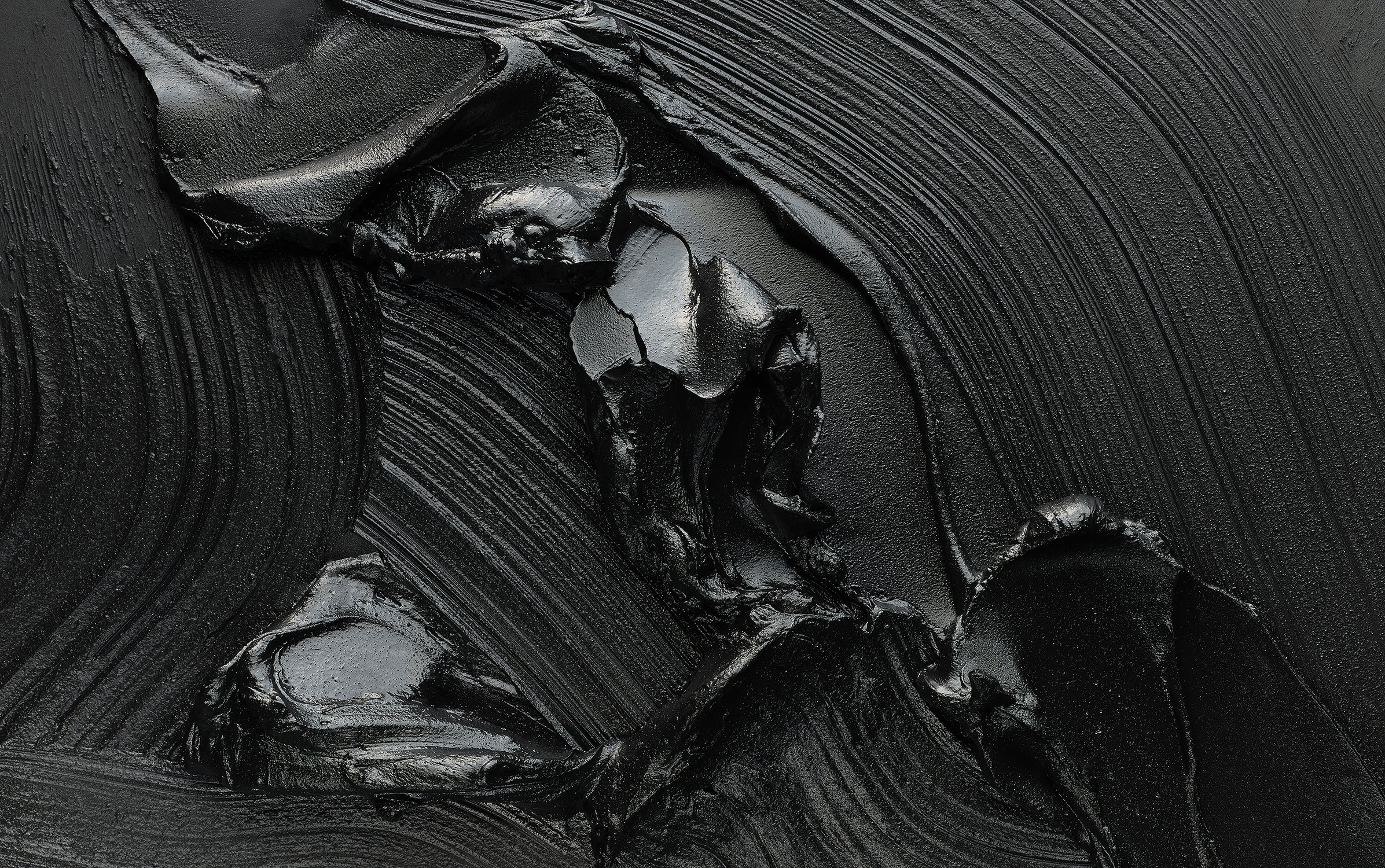 Black abstract painting featuring thick brushstrokes and glossy texture, creating a dramatic, monochromatic artwork with dynamic lines and depth.