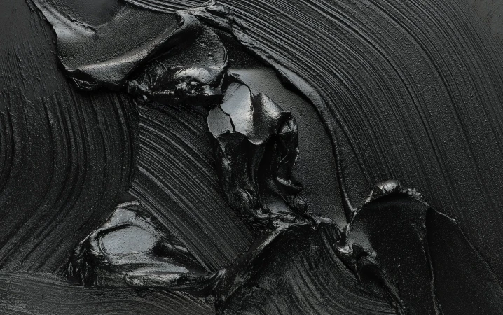 Black abstract painting featuring thick brushstrokes and glossy texture, creating a dramatic, monochromatic artwork with dynamic lines and depth.