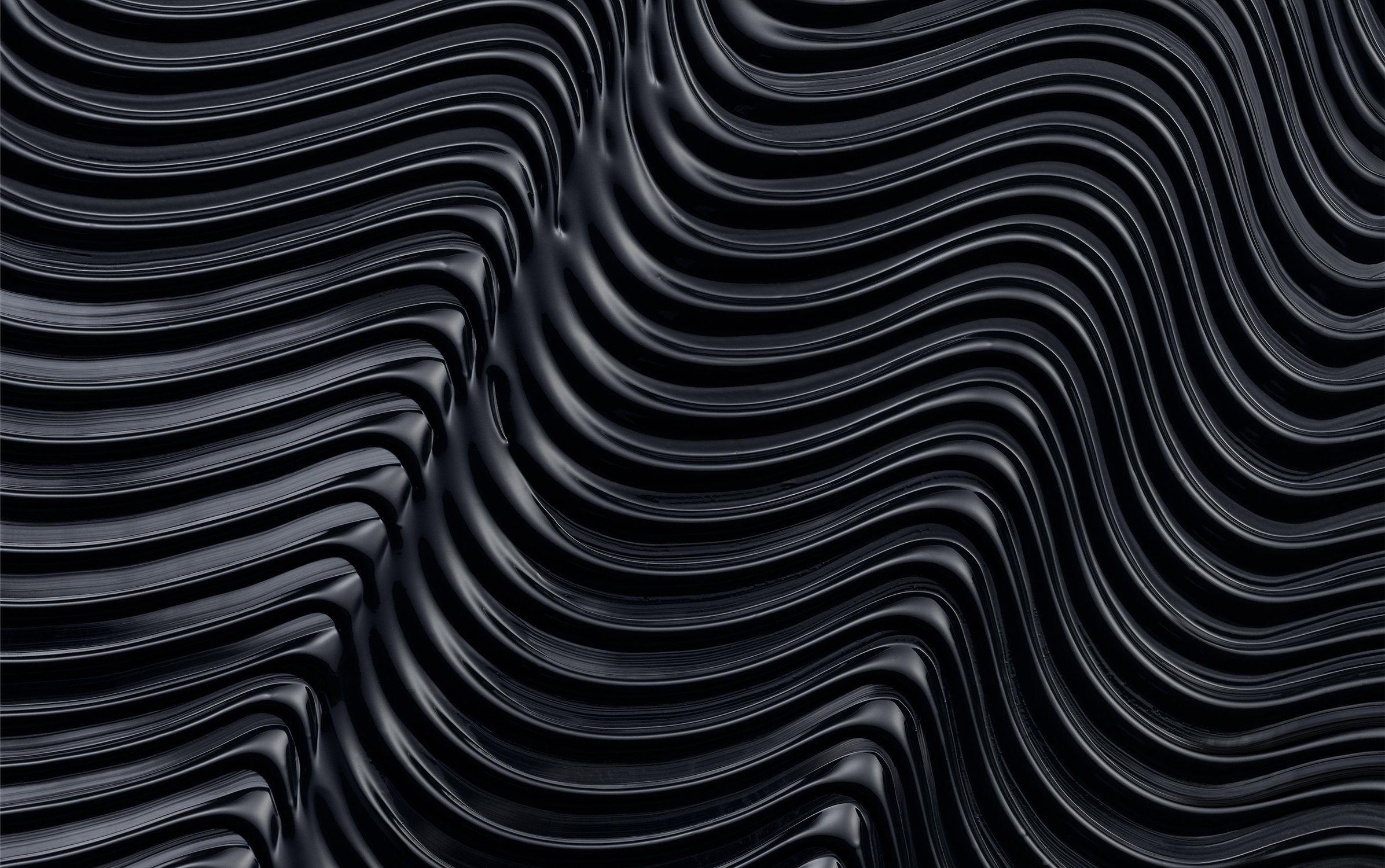 Abstract flowing black lines create a dynamic, dark background with an organic, liquid-like appearance, ideal for textures and design.