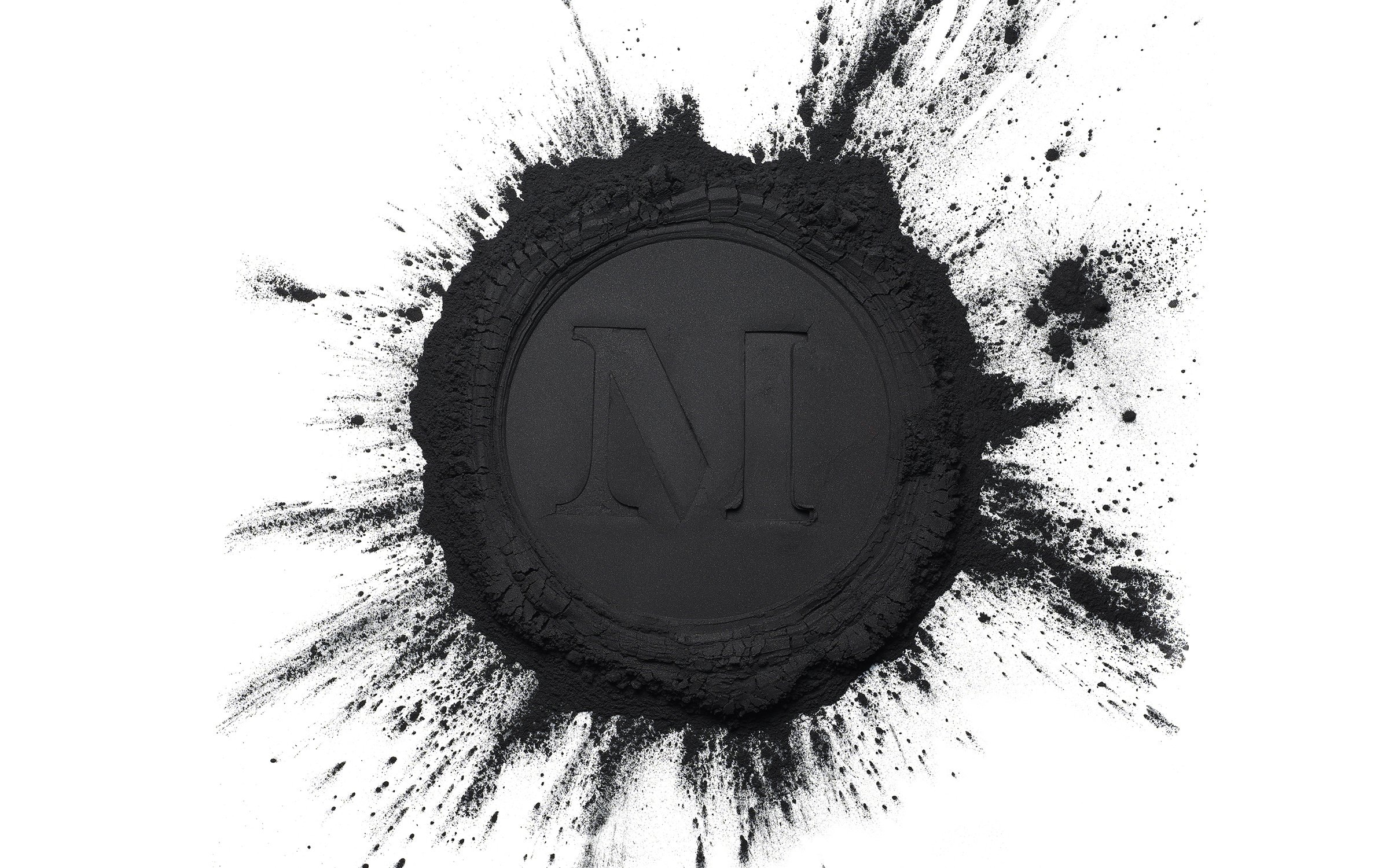 A black powder circle with a capital N in the center, presented on a white background, suitable for beauty or industrial concepts.