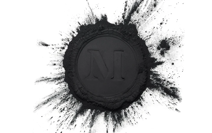 A black powder circle with a capital N in the center, presented on a white background, suitable for beauty or industrial concepts.